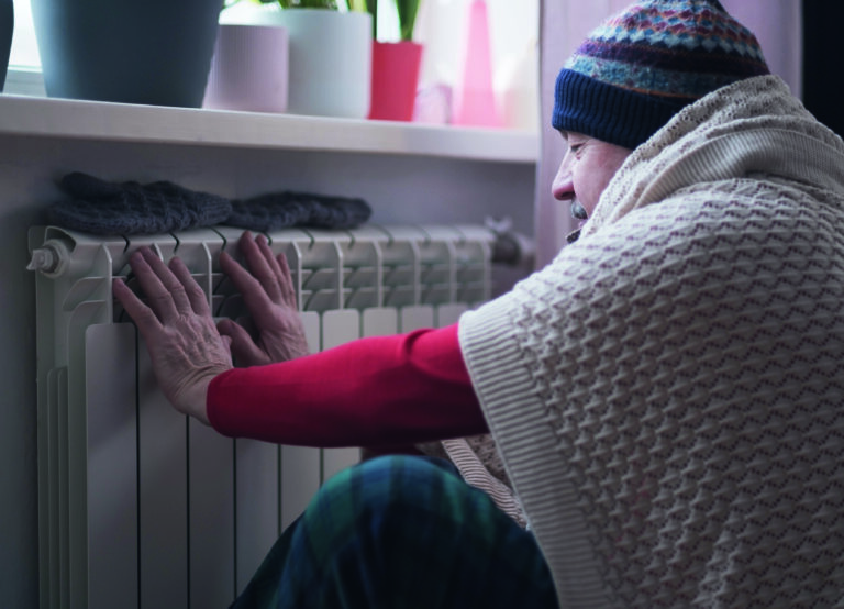 Man Feeling Cold At Home With Home Heating Trouble